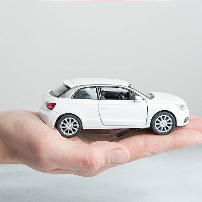 close-up-of-a-car-toy-sitting-on-an-insurance-agents-hand-casper-wy