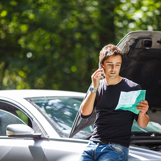 man-looking-at-his-car-insurance-policy-contract-while-talking-on-the-phone-casper-wy